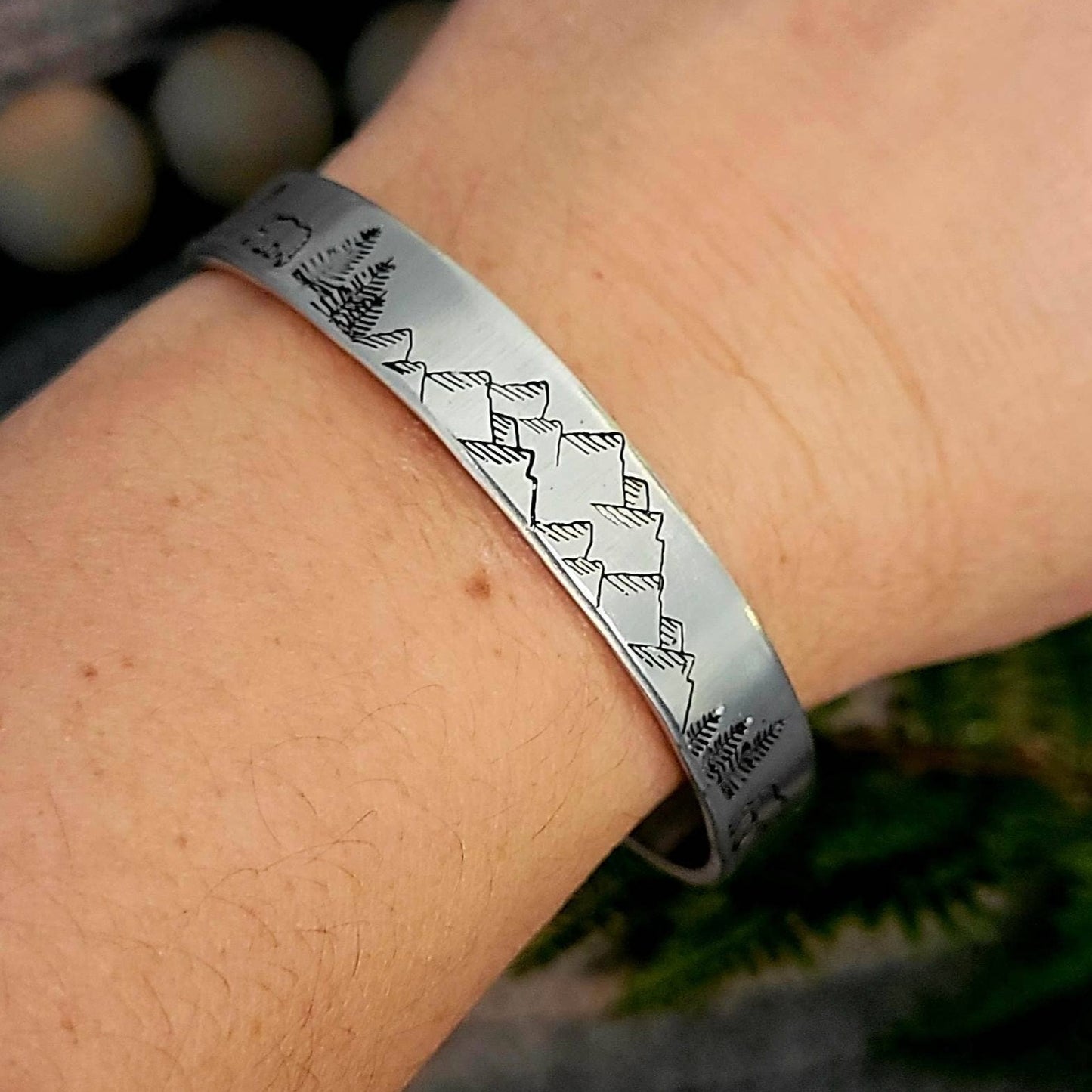 Hand stamped mountain scene aluminum cuff