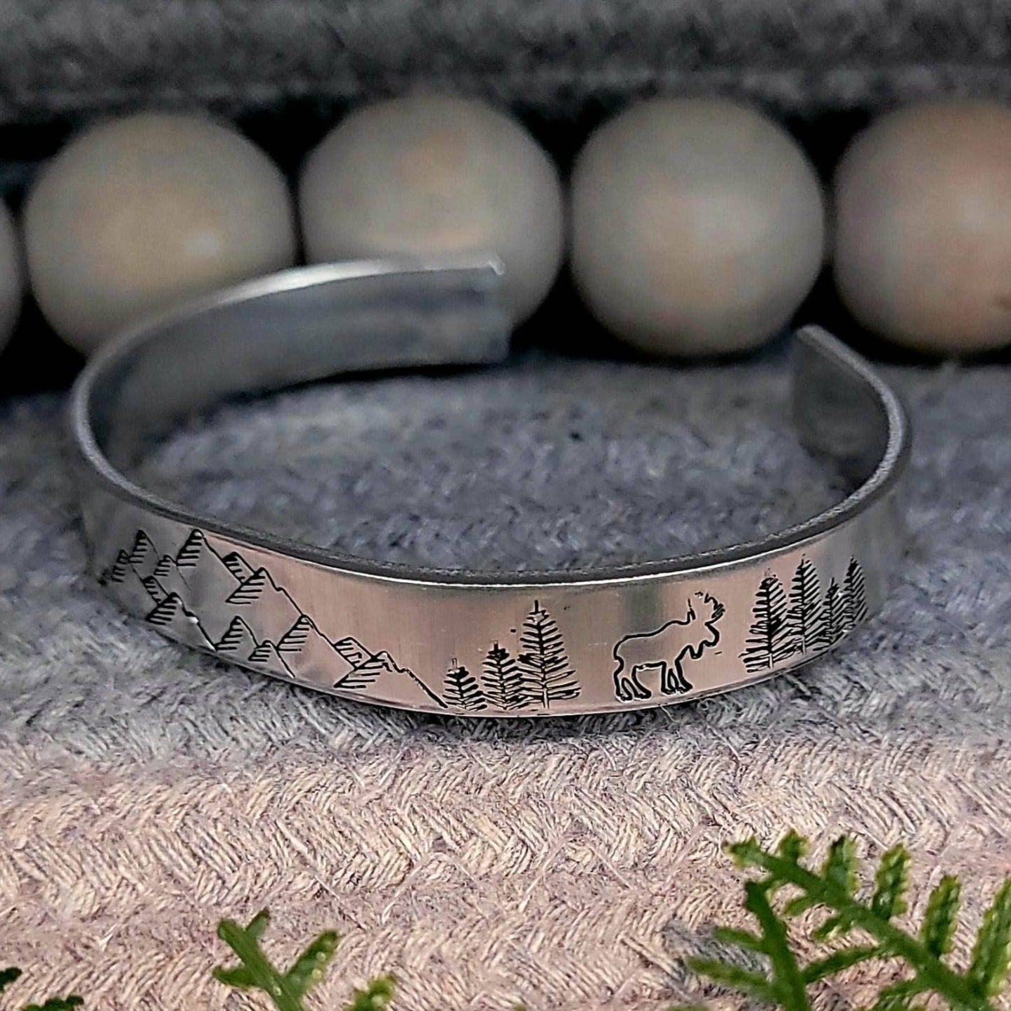 Hand stamped mountain scene aluminum cuff